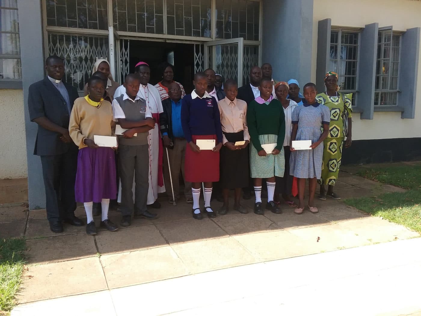 Sister, Priest, and school children
