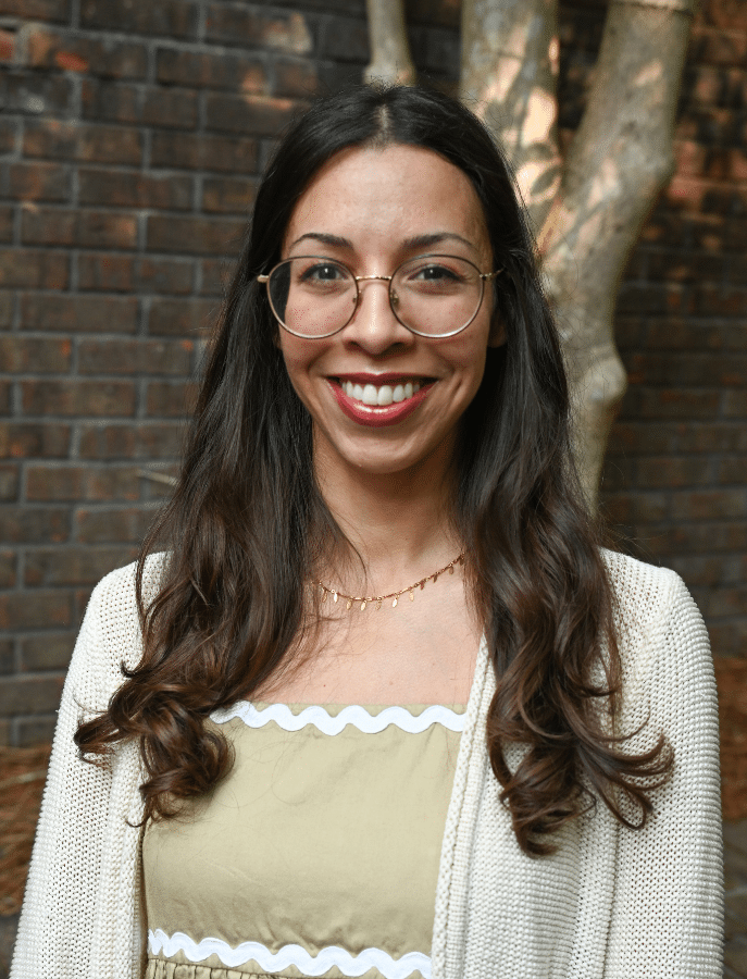 headshot of a woman posing in front of elevated landscaping