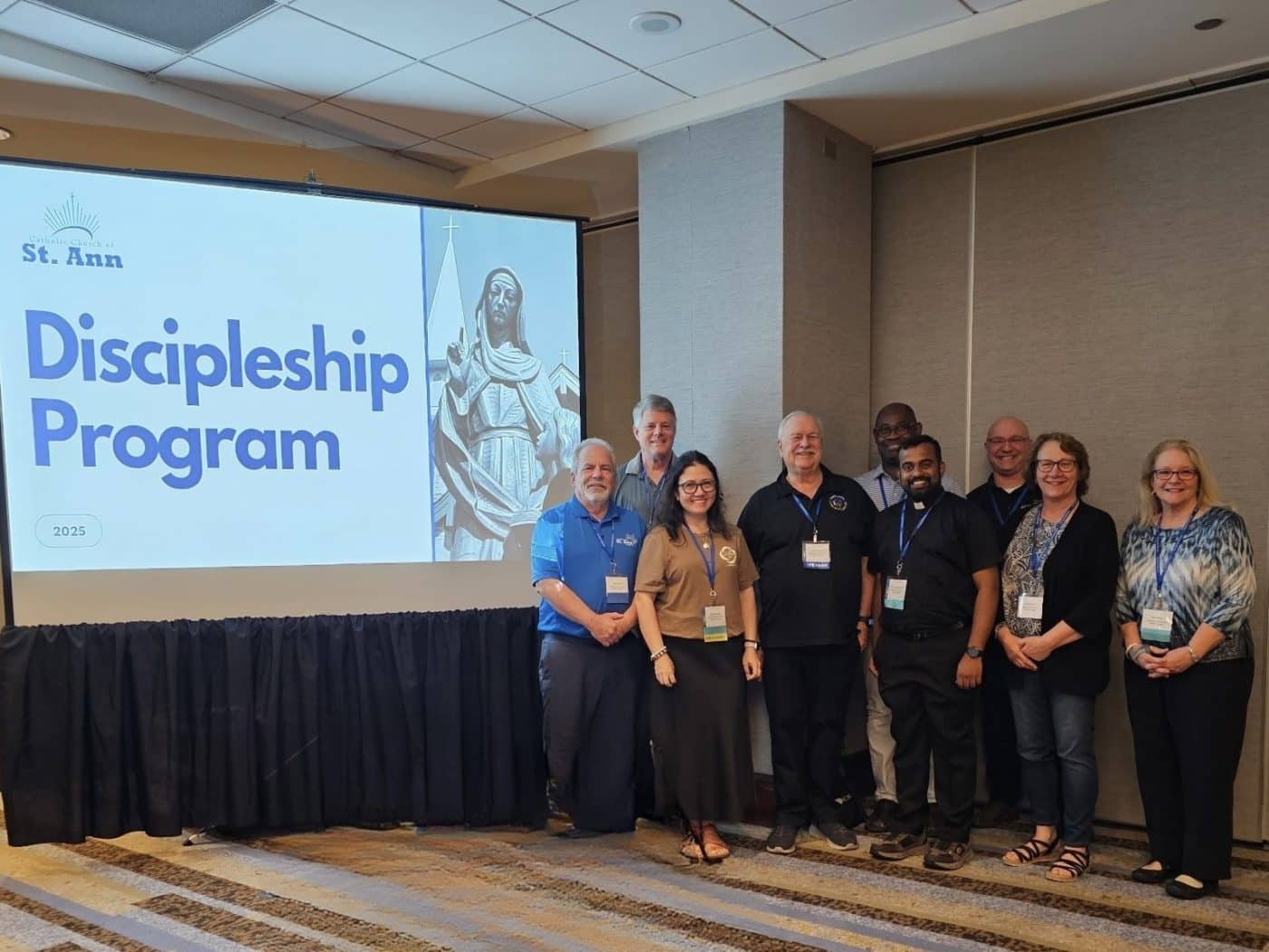People posing in front of a slideshow presentation