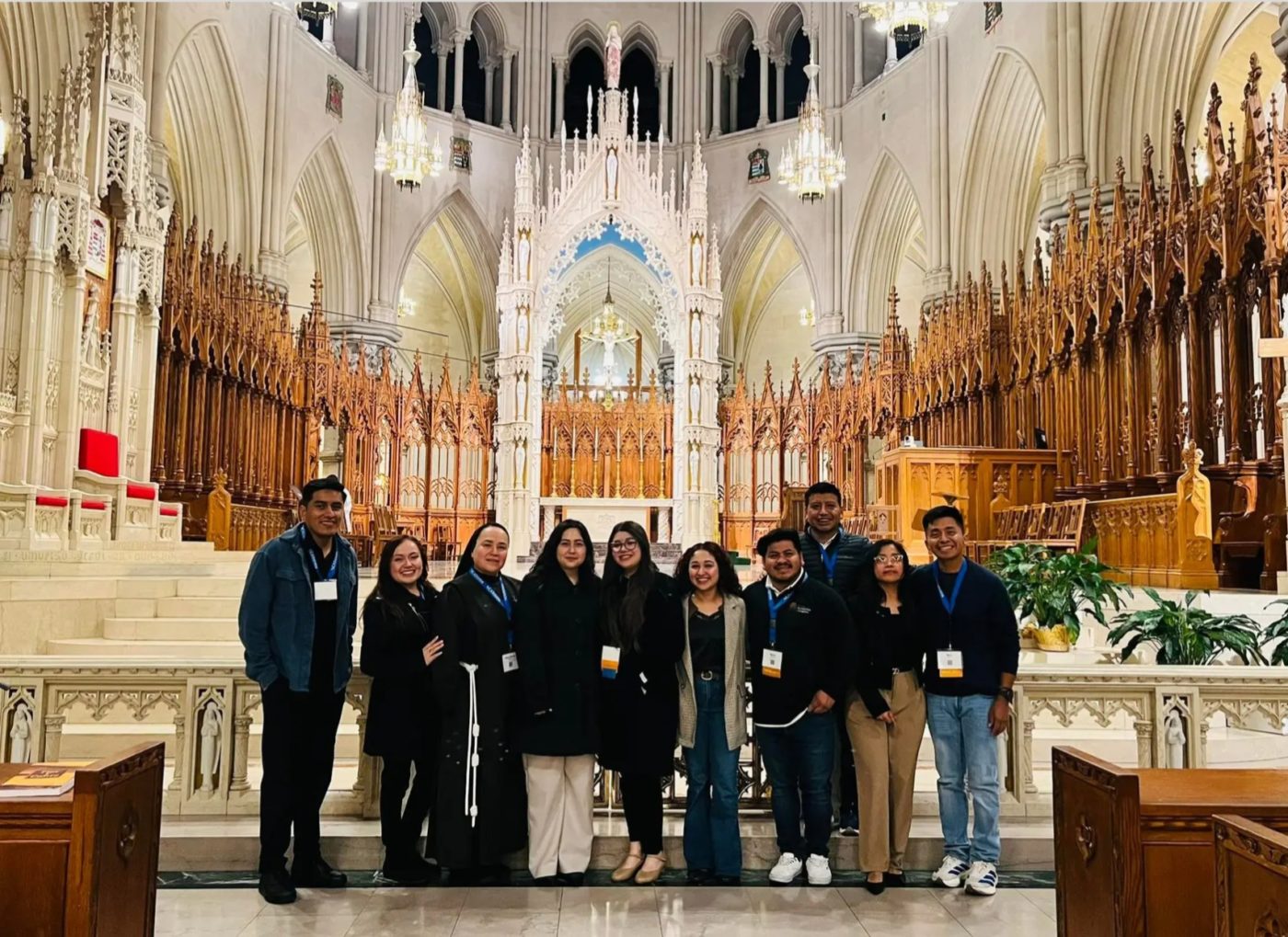 A group of people pose together in front of an altar