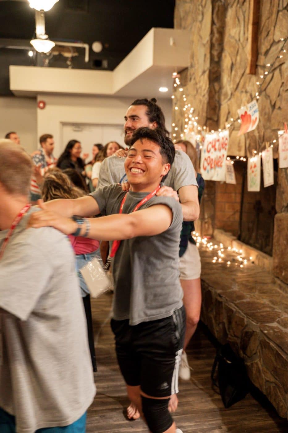 young adults are joined in a conga line