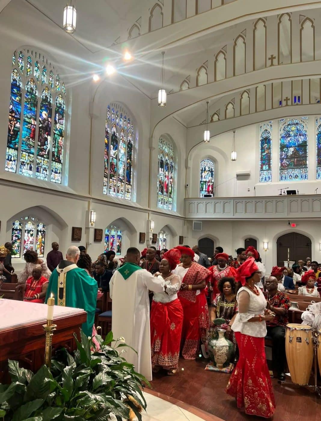 People in cultural outfits in line to receive communion