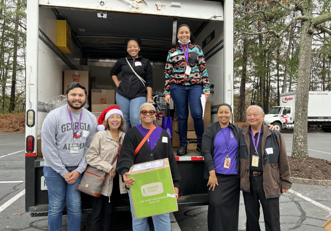 Group moving boxes outside of truck